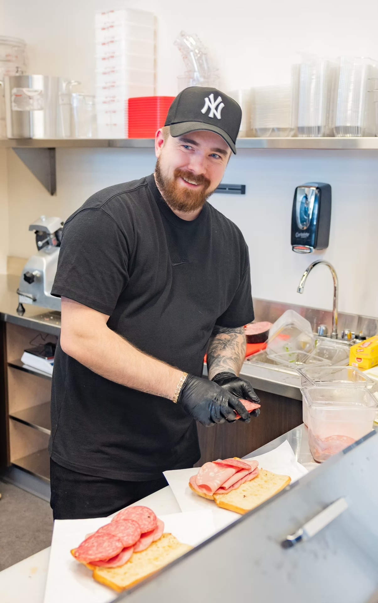 Austin slicing meat behind the counter